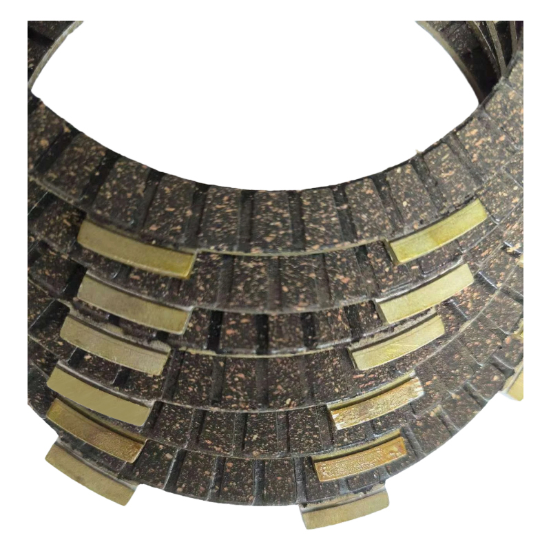 Why can motorcycle friction plates maintain high temperatures without degradation during intense riding?